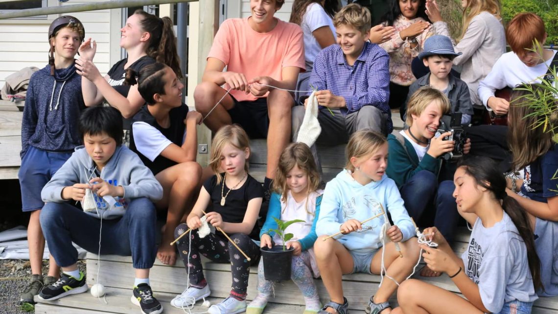 Students at Titirangi Rudolph Steiner School sitting on the steps