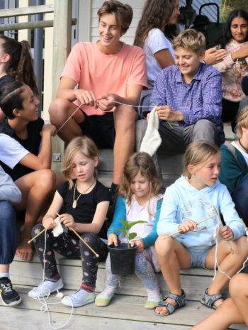 Students at Titirangi Rudolph Steiner School sitting on the steps